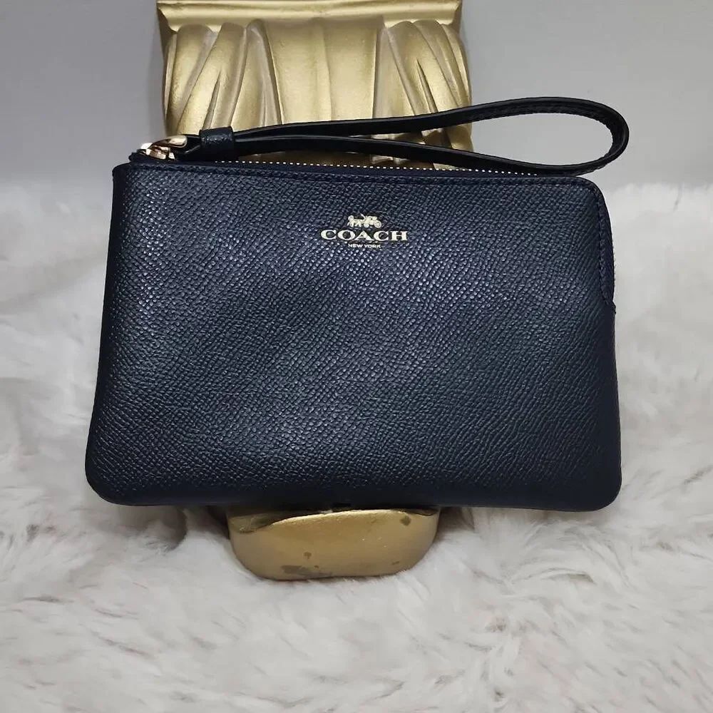 Coach Corner Zip Wristlet in crossgrain leather.